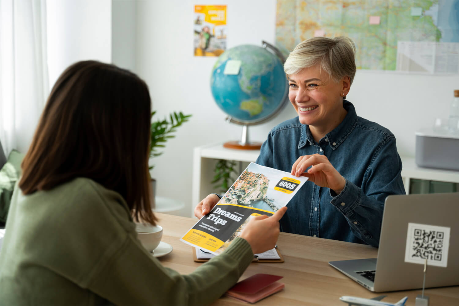 Travel consultant assisting a customer with holiday planning and tour booking